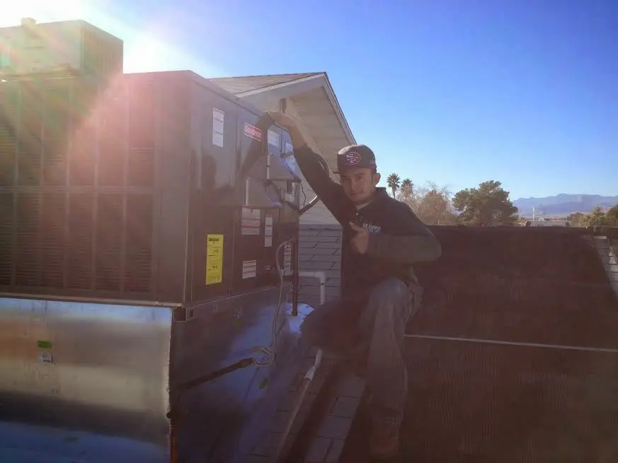 HVAC technician performing HVAC Inspection on a rooftop unit in Sheboygan